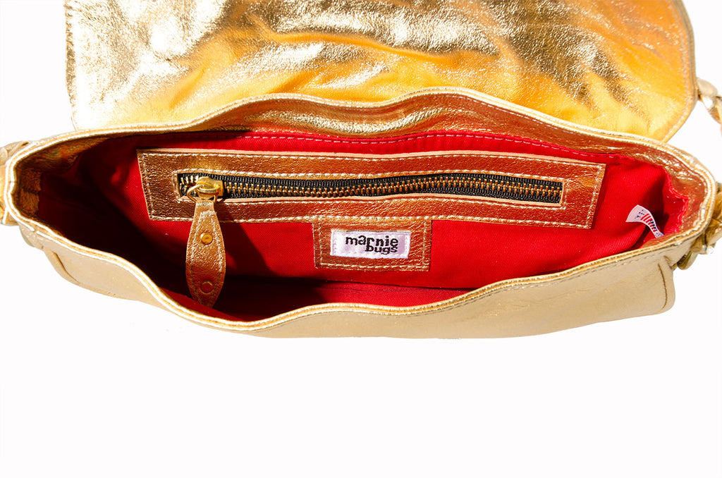 Marnie Bugs Gold Mettalic crafted leather handbag, Marnie Bugs fashinonable shoulder size purse, red fabric lining